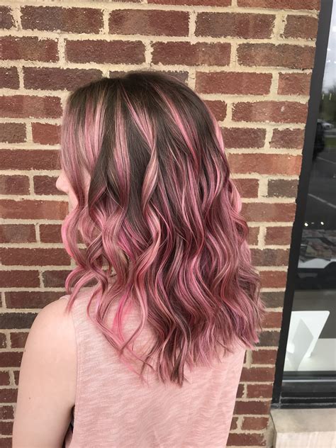 Pastel pink highlights on brown hair